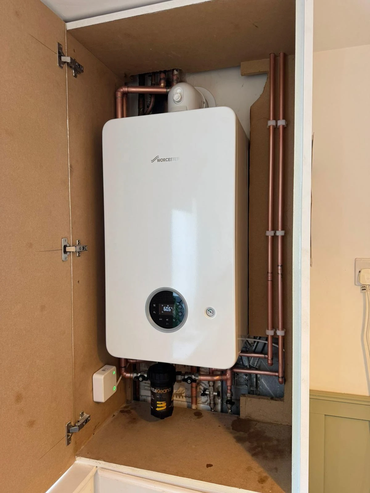 Worcester boiler installation inside a cupboard with copper pipework and magnetic filter